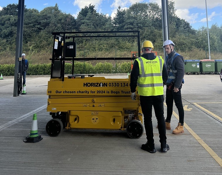 Horizon IPAF instructor showing someone how to use a scissor lift